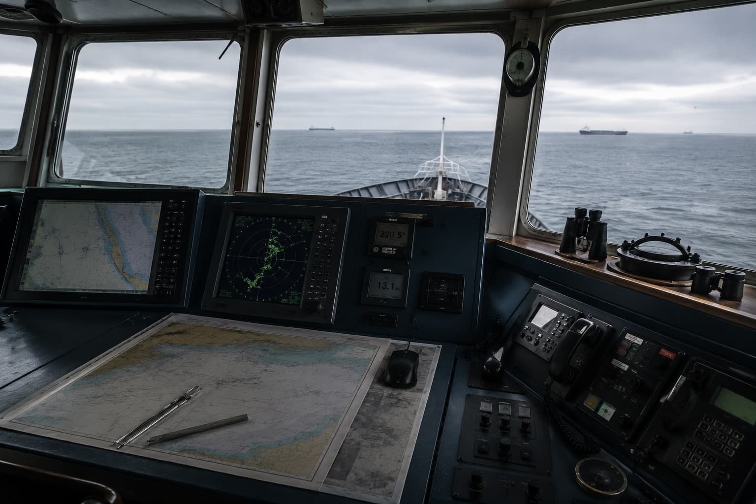 Ship bridge console showing radar, compass and ECDIS instruments